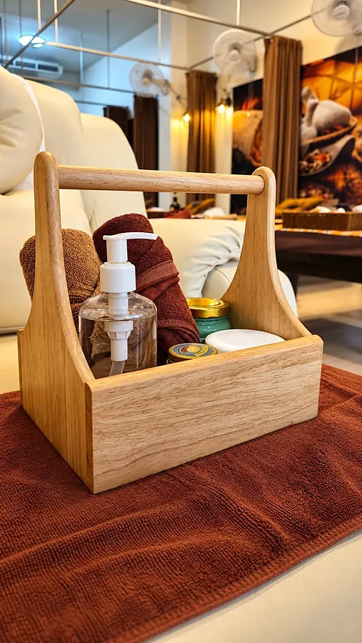 A wooden caddy of massage oils and balms